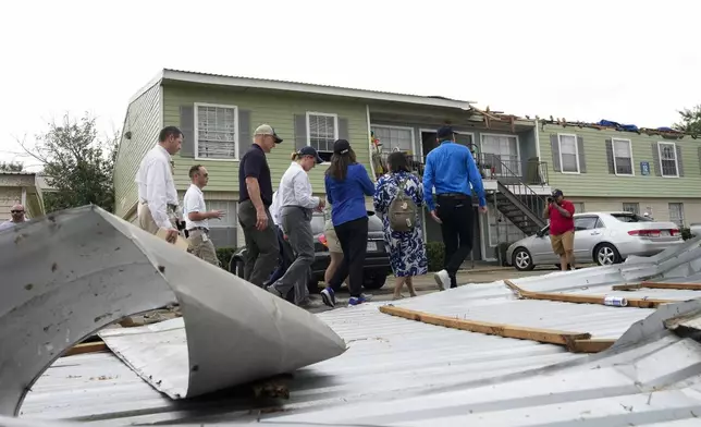FEMA Administrator Deanne Criswell, fourth from left, visits an apartment complex damaged by severe storms the previous week at Spring Branch in Houston, Tuesday, May 21, 2024. (Yi-Chin Lee/Houston Chronicle via AP)