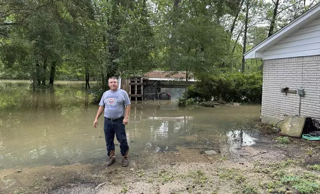 Miguel Flores Sr. stands in his flooded backyard outside his home in the northeast Houston neighborhood of Kingwood on Saturday, May 4, 2024. Officials said the area had about four months of rain in about a week’s time. (AP Photo/Juan Lozano)