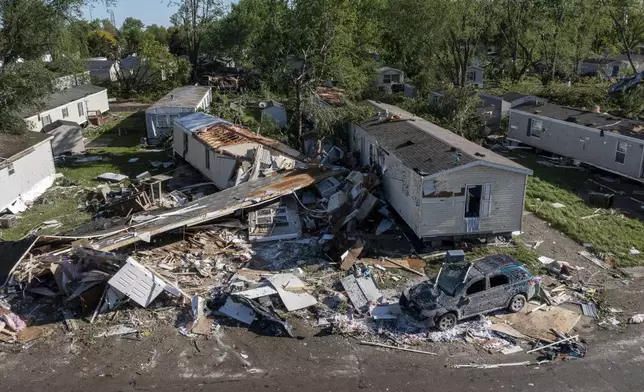 Storm damaged mobile homes are surrounded by debris at Pavilion Estates mobile home park just east of Kalamazoo, Mich. Wednesday, May 8, 2024. A tornado ripped through the area the evening of May 7. (Neil Blake/The Grand Rapids Press via AP)