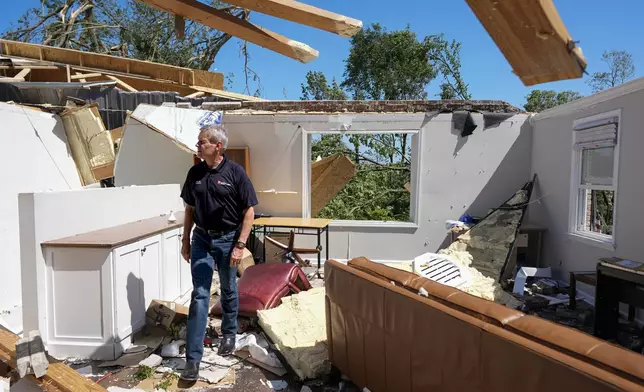 Gov. Bill Lee surveys a storm-damaged home along Blackburn Lane, Thursday, May 9, 2024, in Columbia, Tenn. (AP Photo/George Walker IV)