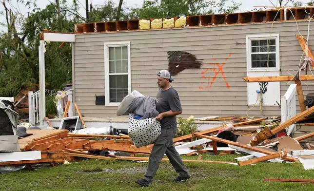Stephen Morgan removes belongings from his storm damaged home along Blackburn Lane, Thursday, May 9, 2024, in Columbia, Tenn. Severe storms tore through the central and southeast U.S., Wednesday, spawning damaging tornadoes, producing massive hail, and killing two people in Tennessee. (AP Photo/George Walker IV)