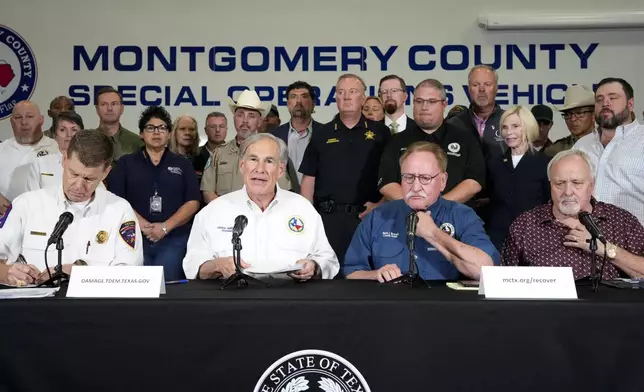 Texas Gov. Greg Abbott, second from left, holds a press conference with local officials to update the state's ongoing response to severe weather and flooding conditions that impacted East Texas communities during a press conference, Monday, May 6, 2024, at Montgomery County Office of Emergency Management Warehouse in Conroe, Texas. Abbott urged people whose properties are damaged to report to the state government as soon as they can. From left are: Texas Division of Emergency Management Chief Nim Kidd, Montgomery County Judge Mark Keough and Liberty County Judge Jay Knight. (Yi-Chin Lee/Houston Chronicle via AP)