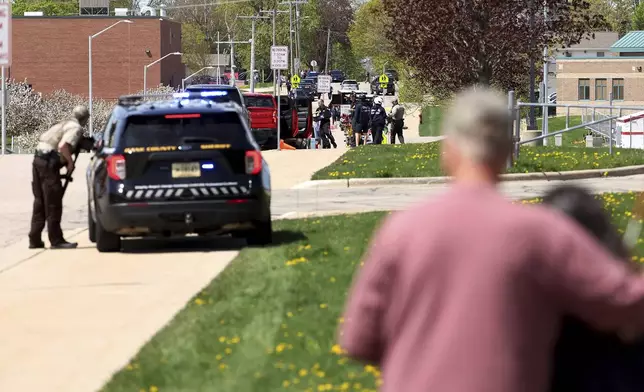 Law enforcement personnel respond to a report of a person armed with a rifle at Mount Horeb Middle School in Mount Horeb, Wis., Wednesday, May 1, 2024. The school district said a person it described as an active shooter was outside a middle school in Mount Horeb on Wednesday but the threat was “neutralized” and no one inside the building was injured. (John Hart/Wisconsin State Journal via AP)