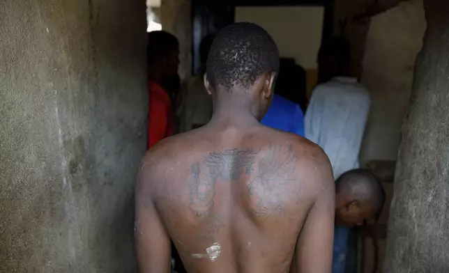 Kush users' queue to receive medical care at a medical outreach center of Sierra Leone's Youth Development and Child Link (SLYDCL), an NGO that provides medical care and psychological needs for drug users, Friday, April 26, 2024. (AP Photo/ Misper Apawu)