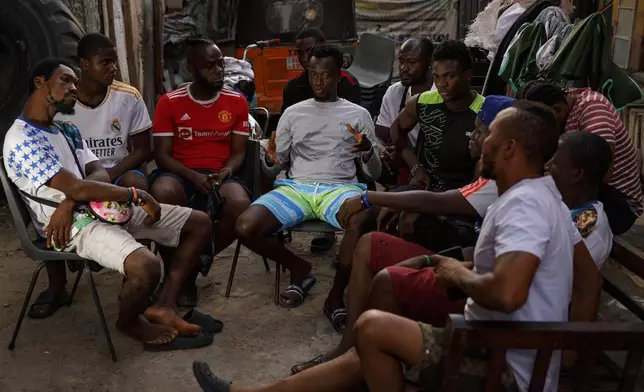 A group of youth meet in Bombay Street in a compound where they rehabilitate Kush users in Freetown, Sierra Leone, Saturday, April 28, 2024. Youth in the Bombay community are helping Kush addicts stop by rehabilitating them in a temporary space. Sierra Leone declared a war on the cheap synthetic drug, calling it an epidemic and a national threat. The drug is ravaging youth, and healthcare services are severely limited. (AP Photo/ Misper Apawu)