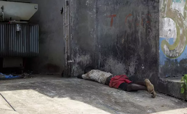 A man sleeps in the shade on the streets of Freetown, Sierra Leone, Sunday, April 28, 2024. Sierra Leone declared a war on Kush, a cheap synthetic drug, calling it an epidemic and a national threat. The drug is ravaging youth, and healthcare services are severely limited. (AP Photo/ Misper Apawu)