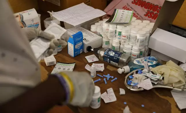 An employee at Sierra Leone Youth Development and Child Link (SLYDCL) provides medical care for Kush users at Moa Wharf, a drug den in Freetown, Sierra Leone, Friday, April 26, 2024. Sierra Leone declared a war on the cheap synthetic drug, calling it an epidemic and a national threat. The drug is ravaging youth, and healthcare services are severely limited. (AP Photo/ Misper Apawu)