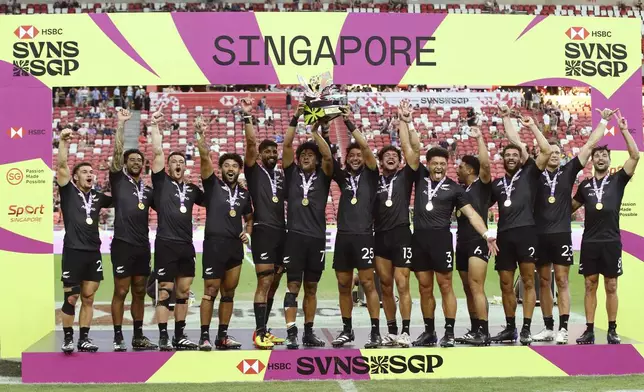 Team New Zealand celebrate winning the men's World Rugby Sevens Series 2024 cup final between Ireland and New Zealand in Singapore, on Sunday, May 5, 2024. (AP Photo/Suhaimi Abdullah)