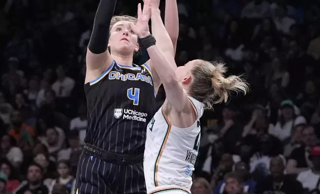 Chicago Sky's Marina Mabrey (4) shoots over New York Liberty's Courtney Vandersloot (22) during the second half of a WNBA basketball game Thursday, May 23, 2024, in New York. The Sky won 90-81. (AP Photo/Frank Franklin II)