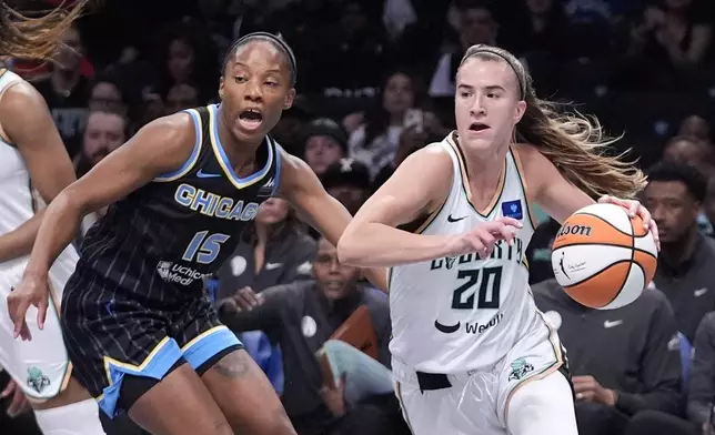 New York Liberty's Sabrina Ionescu (20) drives past Chicago Sky's Lindsay Allen (15) during the first half of a WNBA basketball game Thursday, May 23, 2024, in New York. (AP Photo/Frank Franklin II)