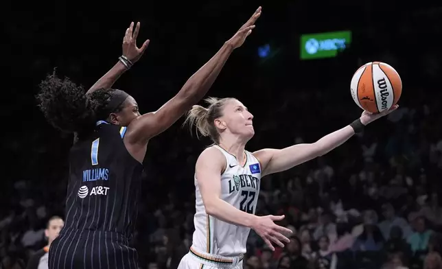 New York Liberty's Courtney Vandersloot (22) drives past Chicago Sky's Elizabeth Williams (1) during the first half of a WNBA basketball game Thursday, May 23, 2024, in New York. (AP Photo/Frank Franklin II)