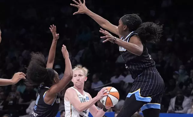 New York Liberty's Courtney Vandersloot, center, looks to pass the ball as Chicago Sky's Elizabeth Williams, right, and Dana Evans defend during the first half of a WNBA basketball game Thursday, May 23, 2024, in New York. (AP Photo/Frank Franklin II)