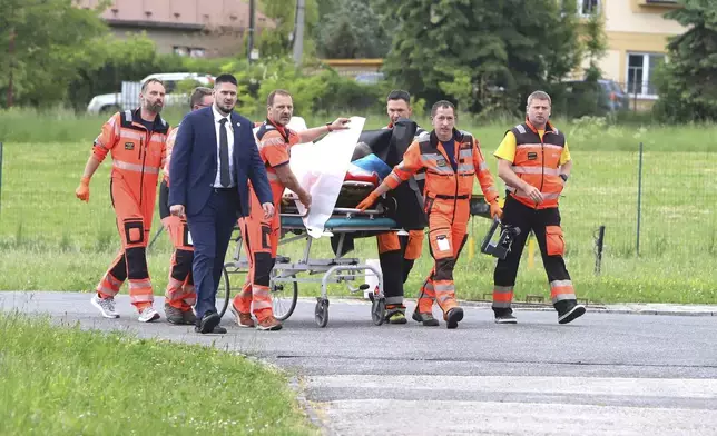 Rescue workers wheel Slovak Prime Minister Robert Fico, who was shot and injured, to a hospital in the town of Banska Bystrica, central Slovakia, Wednesday, May 15, 2024. (Jan Kroslak/TASR via AP)