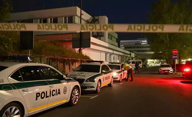 Police cars are parked outside the F. D. Roosevelt University Hospital, where Slovak Prime Minister Robert Fico, who was shot and injured, is treated in Banska Bystrica, central Slovakia, Wednesday, May 15, 2024. Slovak Prime Minister Robert Fico is in life-threatening condition after being wounded in a shooting after a political event Wednesday afternoon, according to his Facebook profile.(AP Photo/Denes Erdos)