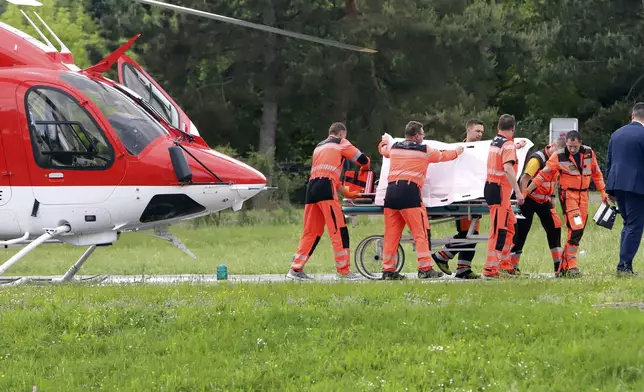 Rescue workers wheel Slovak Prime Minister Robert Fico, who was shot and injured, to a hospital in the town of Banska Bystrica, central Slovakia, Wednesday, May 15, 2024. Slovakia’s populist Prime Minister Robert Fico is in life-threatening condition after being wounded in a shooting Wednesday afternoon, according to his Facebook profile. (Jan Kroslak/TASR via AP)