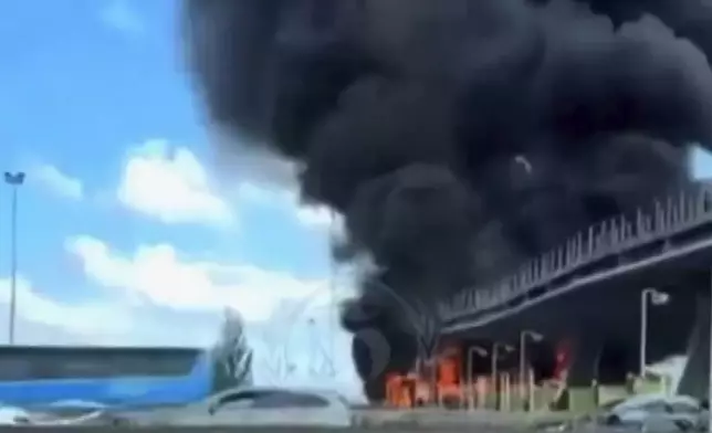 In this photo taken from video released by Hooligans.cz, a fire is seen near Fresnes-Les-Montauban, France, Saturday, May 25, 2024. Lyon and Paris Saint-Germain supporters clashed on a highway leading to the venue of the French Cup final a few hours before kickoff on Saturday.(Hooligans.cz via AP)