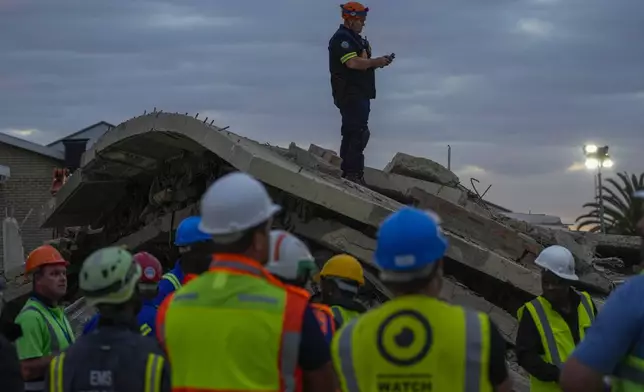 Rescue workers search the site of a building collapse in George, South Africa, Wednesday, May 8, 2024. Nearly 40 construction workers were still missing Wednesday in the rubble of a building that collapsed in South Africa on Monday as rescue teams continued to search for survivors for a third day in the wreckage of the unfinished five-story apartment complex. (AP Photo/Jerome Delay)