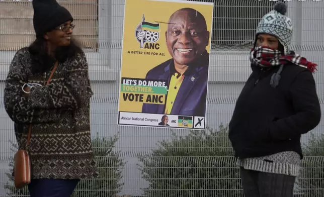 People queue to cast their votes at a polling station in Johannesburg, Wednesday, May 29, 2024. South Africans began voting Wednesday in an election seen as their country’s most important in 30 years, and one that could put their young democracy in unknown territory.(AP Photo/Denis Farrell)