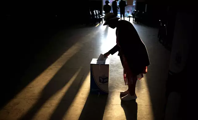 A woman casts her ballot at a polling station, during general elections in Eshowe, South Africa, Wednesday May 29, 2024. South Africans are voting in an election seen as their country's most important in 30 years, and one that could put them in unknown territory in the short history of their democracy, the three-decade dominance of the African National Congress party being the target of a new generation of discontent in a country of 62 million people — half of whom are estimated to be living in poverty. (AP Photo/Emilio Morenatti)