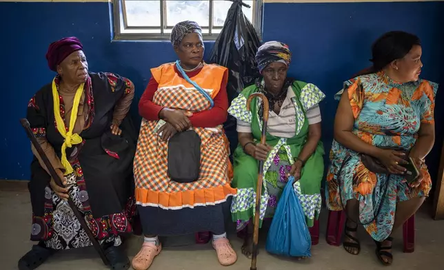 Women wait to cast their ballots on Wednesday May 29, 2024 during general elections in Nkandla, Kwazulu Natal, South Africa. South Africans are voting in an election seen as their country's most important in 30 years, and one that could put them in unknown territory in the short history of their democracy, the three-decade dominance of the African National Congress party being the target of a new generation of discontent in a country of 62 million people — half of whom are estimated to be living in poverty. (AP Photo/Emilio Morenatti)