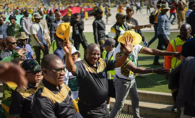 South African President Cyril Ramaphosa greets African National Congress supporters at the Siyanqoba rally at FNB stadium in Johannesburg, South Africa, Saturday, May 25, 2024. South African will vote in the 2024 general elections on May 29. (AP Photo/Jerome Delay)