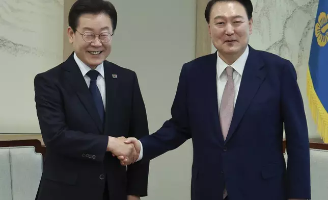 South Korean President Yoon Suk Yeol, right, shakes hands with main opposition Democratic Party leader Lee Jae-myung during a meeting at the presidential office in Seoul South Korea, Monday, April 29, 2024. (Hong Hae-in/Yonhap via AP)