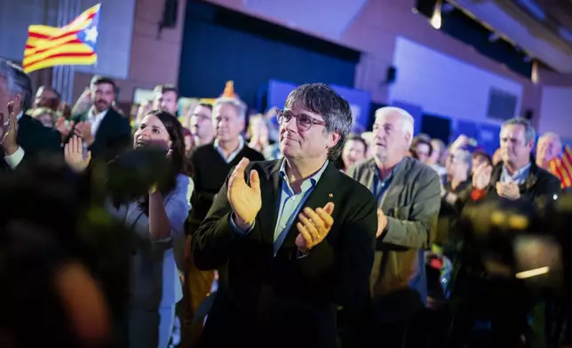 Former regional president Carles Puigdemont applauds during a campaign rally in Argelers, France, Wednesday, May 8, 2024. Carles Puigdemont, Catalonia's fugitive former leader, stares confidently out the backseat window of a car, the sun illuminating his gaze in a campaign poster for Sunday's critical elections in the northeastern Spanish region. Some nearly 6 million Catalans are called to cast ballots in regional elections on Sunday that will surely have reverberations in Spain's national politics. (AP Photo/Joan Mateu)