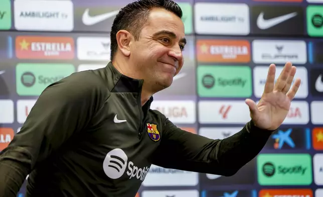 Barcelona's head coach Xavi Hernandez gestures during a press conference in Barcelona, Spain, Saturday, May 25, 2024. Barcelona says coach Xavi Hernandez is leaving the club at the end of the season. The club made the announcement on Friday after a meeting between club president Joan Laporta, Xavi and other senior figures at the team training ground. (AP Photo/Joan Monfort)