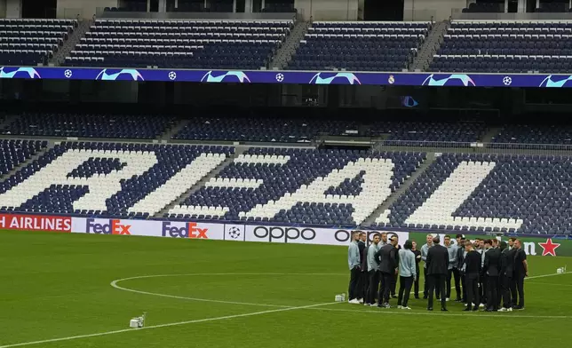 Bayern Munich players stand on the pitch at the Santiago Bernabeu stadium in Madrid, Spain, Tuesday, May 7, 2024. The semifinal second leg Champions League soccer match between Real Madrid and Bayern Munich will be played on Wednesday in Madrid. (AP Photo/Paul White)