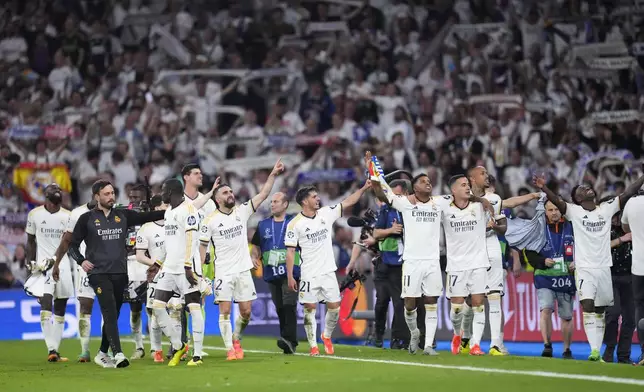 Real Madrid players celebrate at the end of the Champions League semifinal second leg soccer match between Real Madrid and Bayern Munich at the Santiago Bernabeu stadium in Madrid, Spain, Wednesday, May 8, 2024. (AP Photo/Manu Fernandez)