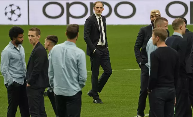 Bayern's head coach Thomas Tuchel, centre, stands on the pitch with his players at the Santiago Bernabeu stadium in Madrid, Spain, Tuesday, May 7, 2024. The semifinal second leg Champions League soccer match between Real Madrid and Bayern Munich will be played on Wednesday in Madrid. (AP Photo/Paul White)