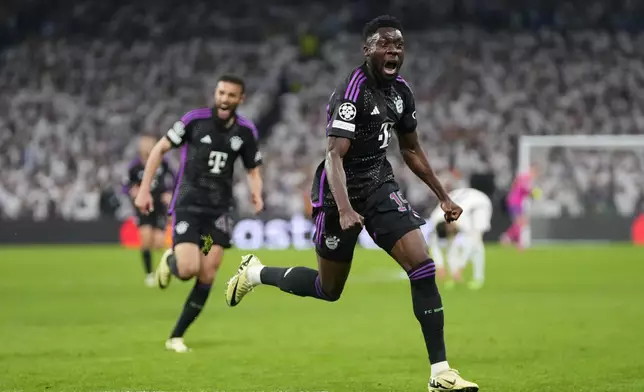 Bayern's Alphonso Davies celebrates after scoring his side's opening goal during the Champions League semifinal second leg soccer match between Real Madrid and Bayern Munich at the Santiago Bernabeu stadium in Madrid, Spain, Wednesday, May 8, 2024. (AP Photo/Manu Fernandez)
