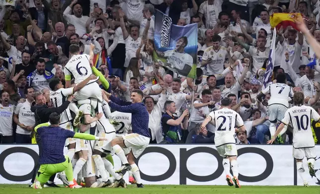 Real Madrid players celebrate after their teammate Joselu scores his side's second goal during the Champions League semifinal second leg soccer match between Real Madrid and Bayern Munich at the Santiago Bernabeu stadium in Madrid, Spain, Wednesday, May 8, 2024. (AP Photo/Manu Fernandez)