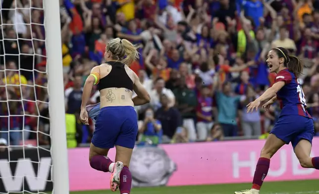 Barcelona's Alexia Putellas, left, celebrates with Aitana Bonmati, right, after scoring her side's second goal during the women's Champions League final soccer match between FC Barcelona and Olympique Lyonnais at the San Mames stadium in Bilbao, Spain, Saturday, May 25, 2024. (AP Photo/Alvaro Barrientos)