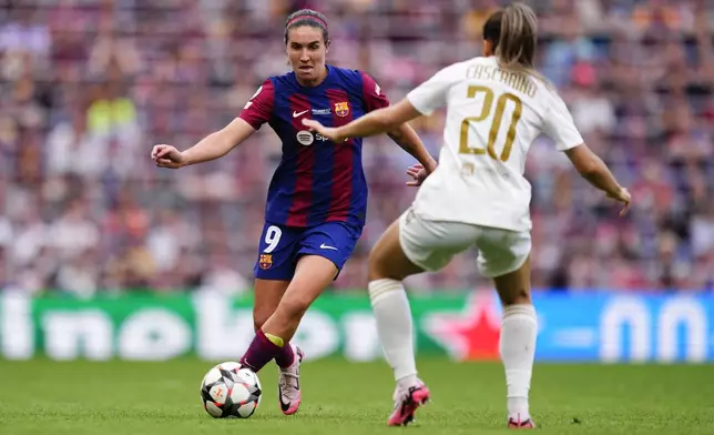 Barcelona's Mariona Caldentey, left, dribbles gthe ball in front of Lyon's Delphine Cascarino during the women's Champions League final soccer match between FC Barcelona and Olympique Lyonnais at the San Mames stadium in Bilbao, Spain, Saturday, May 25, 2024. (AP Photo/Jose Breton)