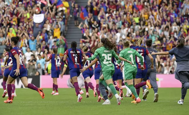 Barcelona players run from the bench celebrating after the final whistle during the women's Champions League final soccer match between FC Barcelona and Olympique Lyonnais at the San Mames stadium in Bilbao, Spain, Saturday, May 25, 2024. Barcelona won 2-0. (AP Photo/Alvaro Barrientos)