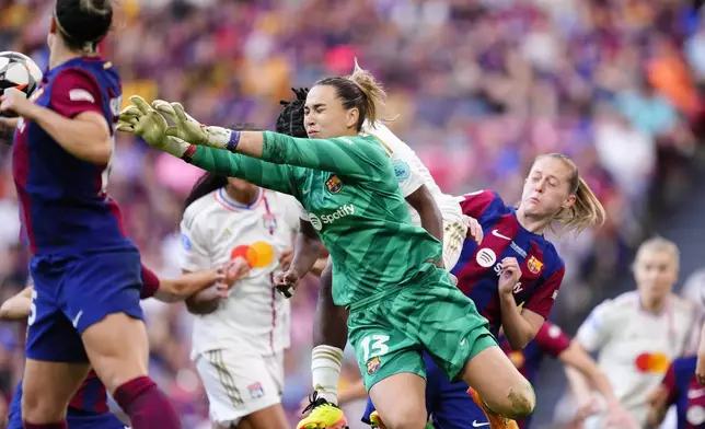 Barcelona goalkeeper Catalina Coll dives for the ball during the women's Champions League final soccer match between FC Barcelona and Olympique Lyonnais at the San Mames stadium in Bilbao, Spain, Saturday, May 25, 2024. (AP Photo/Jose Breton)