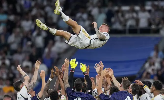 Real Madrid's Toni Kroos is lifted in the air by his teammates during a Spanish La Liga soccer match between Real Madrid and Betis at the Santiago Bernabeu stadium in Madrid, Spain, Saturday, May 25, 2024. Real Madrid said the 34-year-old German international "has decided to bring an end to his time as a professional footballer following Euro 2024".(AP Photo/Manu Fernandez)