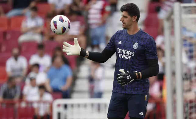 Real Madrid's goalkeeper Thibaut Courtois warms up prior to a Spanish La Liga soccer match between Granada FC and Real Madrid at Los Carmanes stadium in Granada, Spain, Saturday, May 11, 2024. (AP Photo/Fermin Rodriguez)