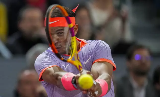 Rafael Nadal, of Spain, returns the ball to Jiri Lehecka, of Czech Republic, during the Mutua Madrid Open tennis tournament in Madrid, Tuesday, April 30, 2024. (AP Photo/Manu Fernandez)