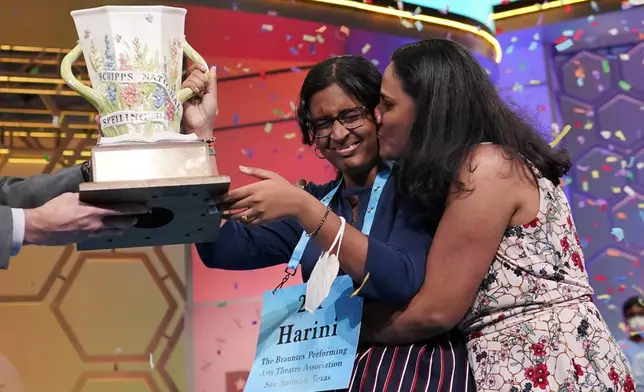FILE - Harini Logan, 14, from San Antonio, Texas, gets a kiss from her mom Rampriya Logan on stage as she celebrates winning the Scripps National Spelling Bee, Thursday, June 2, 2022, in Oxon Hill, Md. Since 1999, 28 of the last 34 Scripps National Spelling bee champions have been Indian American. The experiences of first-generation Indian Americans and their spelling bee champion children illustrate the economic success and cultural impact of the nation’s second-largest immigrant group. (AP Photo/Alex Brandon, File)