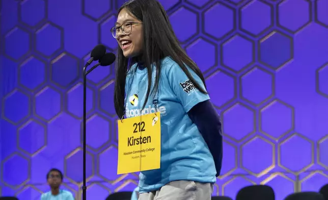 Kirsten Tiffany Santos, 13, of Richmond, Texas, smiles as she spells correctly earning her a place in the finals, during the semifinals of the Scripps National Spelling Bee, in Oxon Hill, Md., Wednesday, May 29, 2024. Eight spellers will head to Thursday's finals. (AP Photo/Jacquelyn Martin)