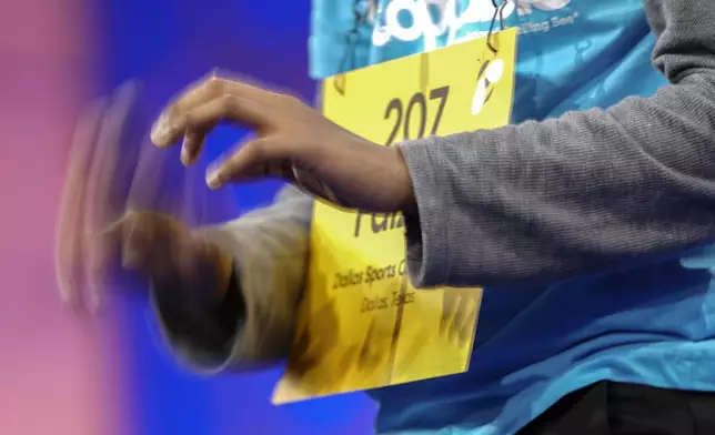 Faizan Zaki, 12, of Allen, Texas, gestures with his fingers as he figures out how to spell a word during the finals of the Scripps National Spelling Bee, in Oxon Hill, Md., Thursday, May 30, 2024. (AP Photo/Nathan Howard)