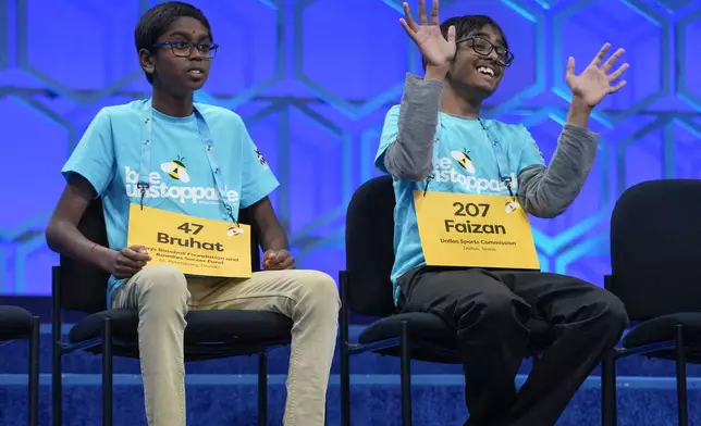 Bruhat Soma, 12, of Tampa, Fla., and Faizan Zaki, 12, of Allen, Texas, compete in the finals of the Scripps National Spelling Bee, in Oxon Hill, Md., Thursday, May 30, 2024. (AP Photo/Jacquelyn Martin)