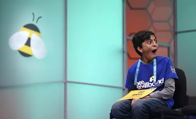 Shrey Parikh, 12, of Rancho Cucamonga, Calif., reacts to a fellow competitor's word during the finals of the Scripps National Spelling Bee, in Oxon Hill, Md., Thursday, May 30, 2024. (AP Photo/Nathan Howard)