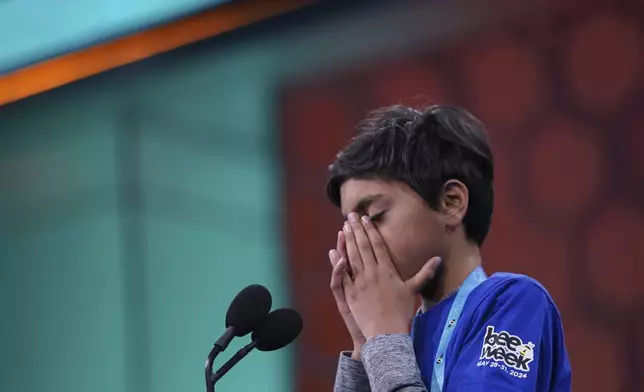 Shrey Parikh, 12, of Rancho Cucamonga, Calif., reacts after spelling a word incorrectly during the finals of the Scripps National Spelling Bee, in Oxon Hill, Md., Thursday, May 30, 2024. (AP Photo/Nathan Howard)