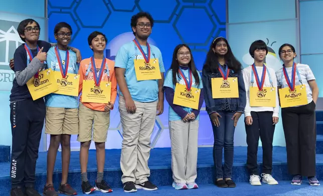 The final eight competitors of the Scripps National Spelling Bee pose for a group photograph after the conclusion of the semifinals, in Oxon Hill, Md., Wednesday, May 29, 2024. These eight spellers will continue on to Thursday night's finals. From left they are, Faizan Zaki, 12, of Allen, Texas, Bruhat Soma, 12, of Tampa, Fla., Shrey Parikh, 12, of Rancho Cucamonga, Calif., Rishabh Saha, 14, of Merced, Calif., Kirsten Tiffany Santos, 13, of Richmond, Texas, Aditi Muthukumar, 13, of Westminster, Colo., YY Liang, 12, of Hartsdale, N.Y., and Ananya Rao Prassanna, 13, Apex, North Carolina. (AP Photo/Jacquelyn Martin)