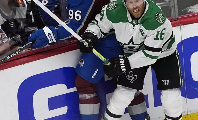 Dallas Stars center Joe Pavelski, right, checks Colorado Avalanche right wing Mikko Rantanen during the first period of Game 6 of an NHL hockey playoff series Friday, May 17, 2024, in Denver. (AP Photo/David Zalubowski)