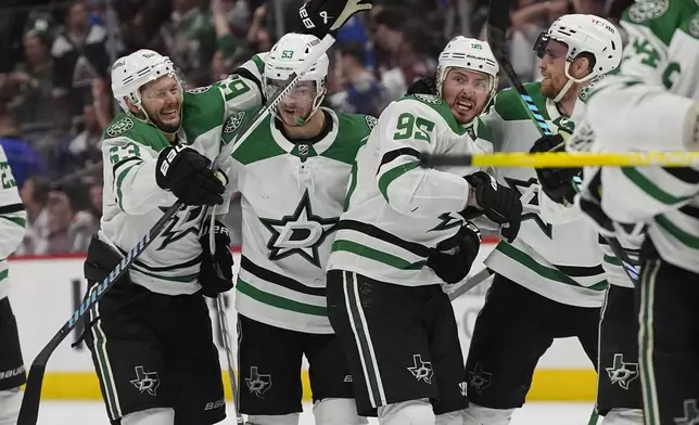 Dallas Stars center Matt Duchene, third from left, is congratulated after scoring the winning goal by, from left, right wing Evgenii Dadonov and centers Wyatt Johnston and Radek Faksa in the second overtime of Game 6 of an NHL hockey playoff series Friday, May 17, 2024, in Denver. (AP Photo/David Zalubowski)