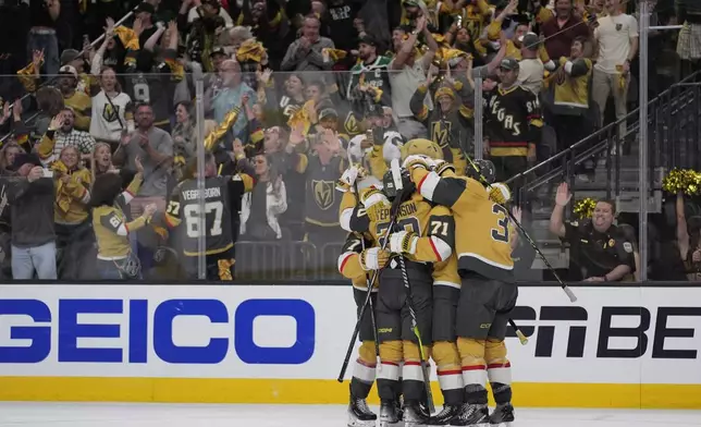 Vegas Golden Knights celebrate after a goal by Vegas Golden Knights right wing Mark Stone (61) during the third period in Game 6 of an NHL hockey Stanley Cup first-round playoff series Friday, May 3, 2024, in Las Vegas. (AP Photo/John Locher)
